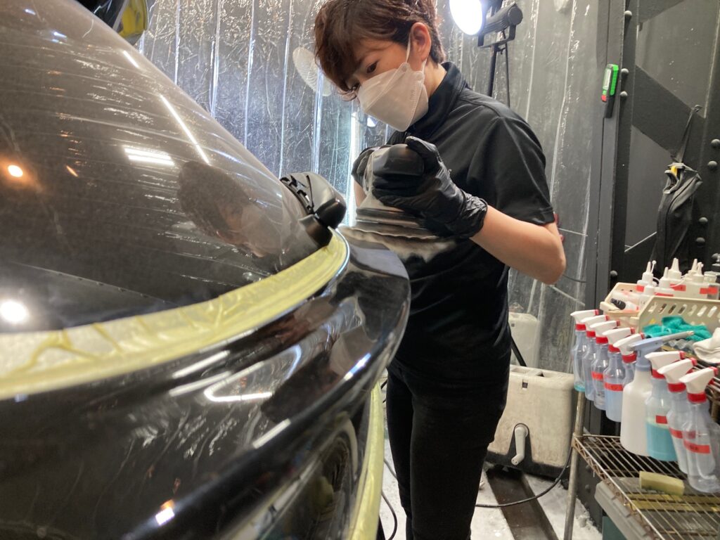スバル・レヴォーグのペンキ除去作業工程：リアゲートを磨いている様子