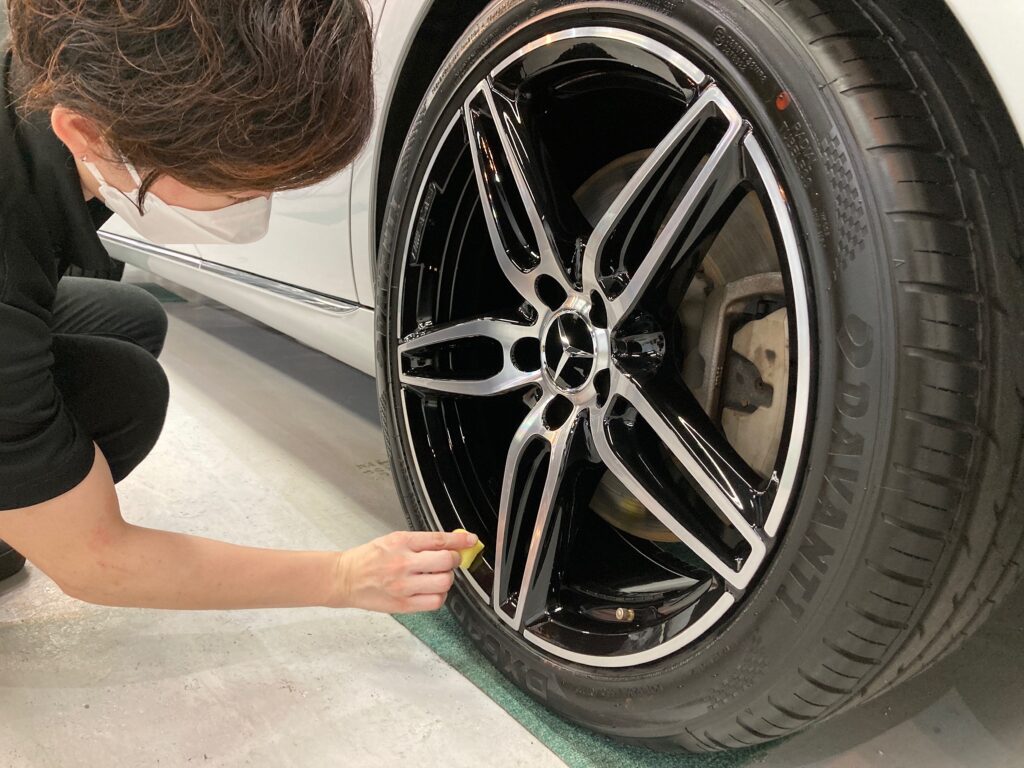 メルセデス・ベンツ・Eクラス：クラスM施工：仕上げ作業工程：ホイールにコーティング剤を塗布している様子
