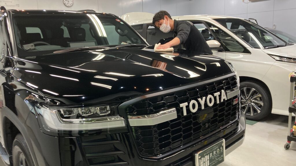 トヨタ・ランドクルーザー：クラスM施工：仕上げ作業工程：コーティング剤を塗布後、レベリングしている様子