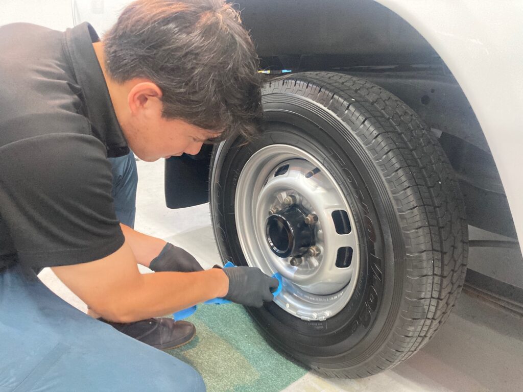 日産・ダットサン：クラスＭ施工：仕上げ作業工程：ホイールを拭き上げている様子