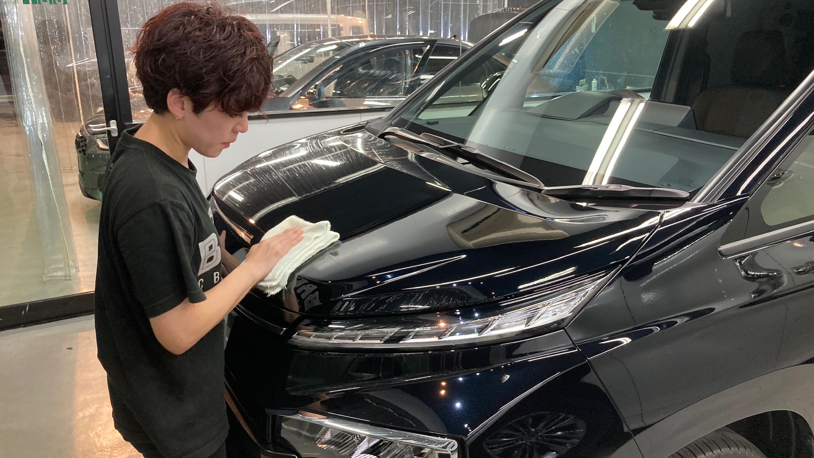 トヨタ・ヴォクシー：クラスM施工：仕上げ作業工程：コーティング剤を塗布後、レベリングしている様子